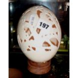 Carved pierced ostrich egg with pictures of lizards & trees