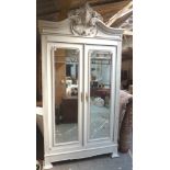 19th c. Continental painted pine armoire having two mirrored doors under ornately carved pediment