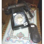 Old bakelite telephone, and a cased pair of opera glasses