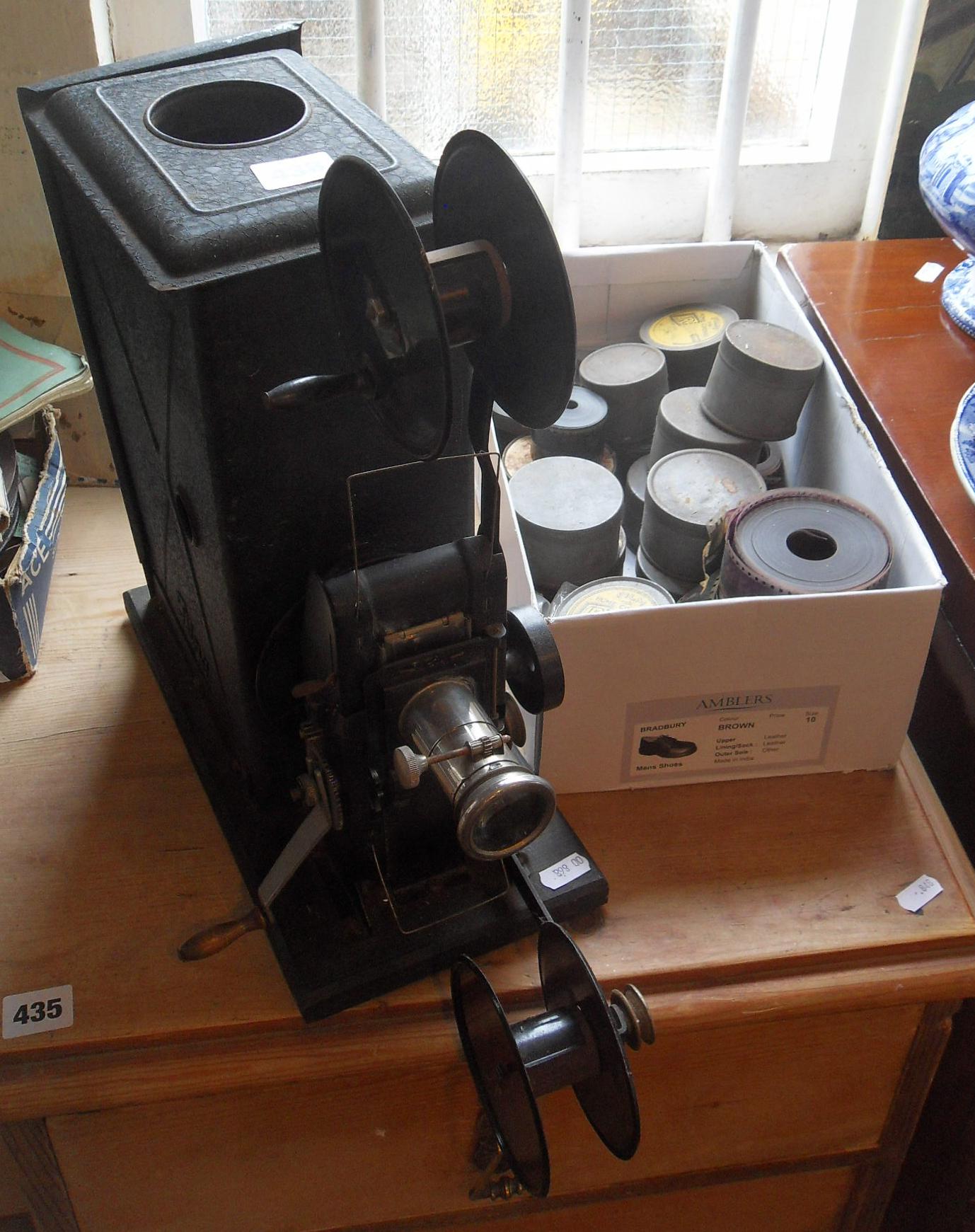 Bing tinplate cine film projector c.1910, and a collection of 45mm films including WW1 warships