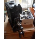 Bing tinplate cine film projector c.1910, and a collection of 45mm films including WW1 warships