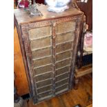 Old Indian carved hardwood two-door cupboard with brass embellished panelled doors enclosing