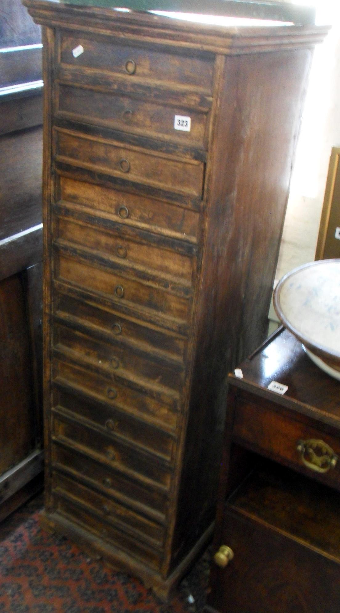 Tall narrow collector's chest of fourteen drawers