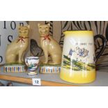 Pair of Staffordshire cats, a Watcombe Torquay Widecombe Fair jug, and a Quimper eggcup