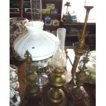 Two oil lamps, a student's candlestick, and a pair of clock garnitures on marble bases