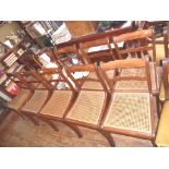 A fine set of ten Regency inlaid rosewood sabre legged dining chairs with cane seats