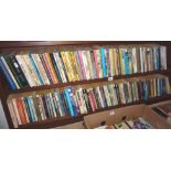 Two shelves of vintage paperbacks including some 1960s pulp fiction