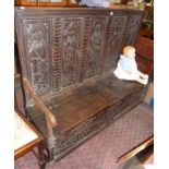 Early 17th c. oak settle with carved box seat having later carved panels to back, 5ft long