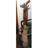 Set of old hickory-shafted golf clubs in canvas bag