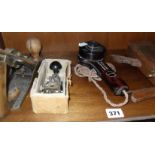A Morse key, a Bakelite microphone and two old woodwork planes