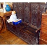 Early 17th c. oak settle with carved box seat having later carved panels to back, 5ft long