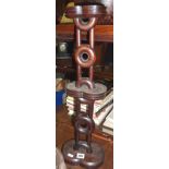 Tribal Art:- Oriental turned rosewood stand of sculptural form of graduated concentric rings, 23"