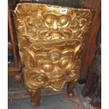 Tribal Art:- Far-Eastern gold-leafed chair made from a solid piece of teak with Hindu Deity face