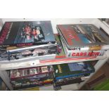 Two shelves of Formula One Yearbooks, and other Grand Prix and motor related books, and a large