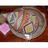 Tribal Art:- Beaded woven basket with lid, a Zulu pottery bowl (A/F), Nyami stick (A/F)