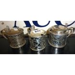 Three pierced silver mustard pots (one missing blue glass liner), Mappin & Webb, Sheffield 1899,