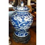 Chinese blue & white lidded prunus pattern baluster vase (A/F) on carved hardwood stand, 15"