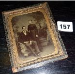 A framed Victorian tintype image of a husband & wife