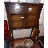 Cross-banded walnut set of small drawers standing on elongated cabriole legs, 25" tall x 16" wide