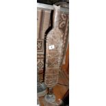 Tribal Art:- a 19th c. Bedouin tent peg mounted on stand