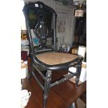 Victorian ebonised nursing chair with cane seat