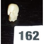 Carved miniature mother-of-pearl skull