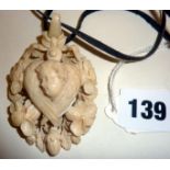 19th c. finely carved ivory locket with winged cherub over an inset photograph frame, surrounded