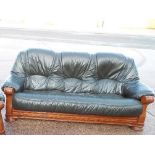 A wooden carved three seater sofa with g