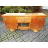 An oak sideboard with ornate drawers and