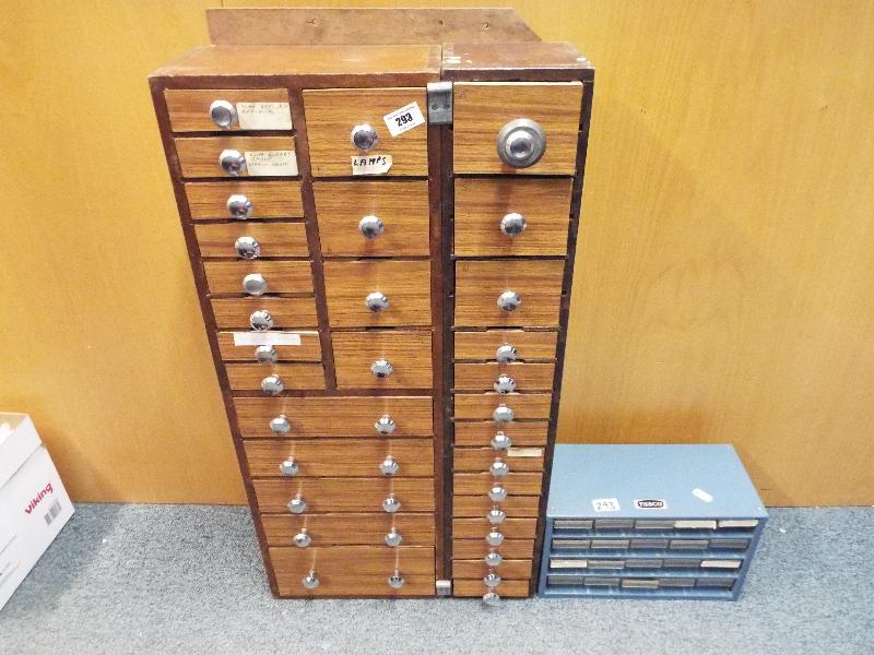 A handyman's wall or bench mounted chest of 30+ small drawers and a small metal chest of screw