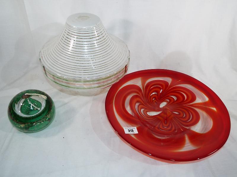 A large art glass bowl in shades of red