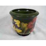 Moorcroft Pottery - a jardiniere decorated with coral hibiscus on a green ground,