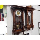 A Vienna style wall clock in a walnut case with carved and turned decoration,