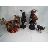 A mixed lot to include a pair of wooden tribal figures, a hardwood carved buffalo,