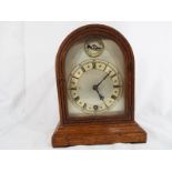 An oak cased dome topped mantel clock by W&H,