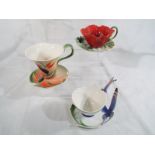 Three cups and saucers with applied floral decoration by Franz