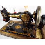 A hand cranked early 20th century Jones sewing machine marked As Supplied to Her Majesty Queen