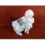 A good quality ceramic posy vase in the form of a cherub and cradle,