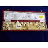 A 19th century highly carved ivory pendant with 16 graduated filigree beads and a small quantity of