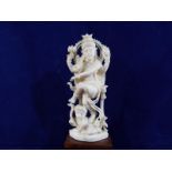 A 19th century carved ivory figure depicting a goddess and child on a wooden plinth,