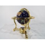 A small lapis lazuli world globe in ornamental stand approximately 20 cm (h)