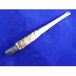 A 19th century ivory and white metal cheroot holder with ornate carving depicting foliage and a