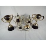 A good quality plated tea and coffee set and two twin-handled trophy cups