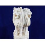 A 19th century carved ivory figure in the form of multiple headed lions on a plinth,