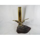 Trench Art incorporating a brass depiction of an eagle on a rock before a shell 32 cm (h)