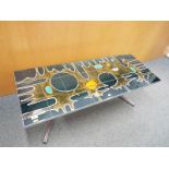 A retro chrome coffee table decorated wi