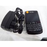 A Blackberry model No. 9780 with charger