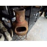 A terracotta Chiminea, 90 cm (high) on s