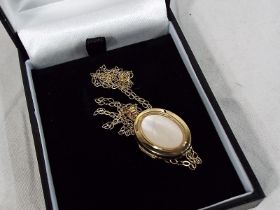 A 9 carat gold mother of pearl locket wi