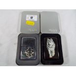 Zippo - two Zippo lighters with depictions of wolves,